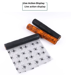 Detail of Halloween mesh rolls with spider web and skull patterns for party table decor