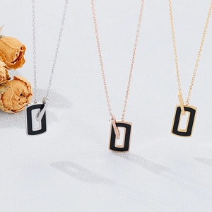 Detailed view of square pendant necklaces in silver, gold, and rose gold finishes