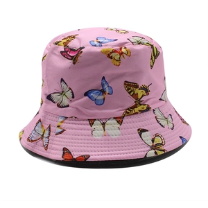 Detail of pink cotton bucket hat featuring colorful butterfly prints and parallel brim stitching