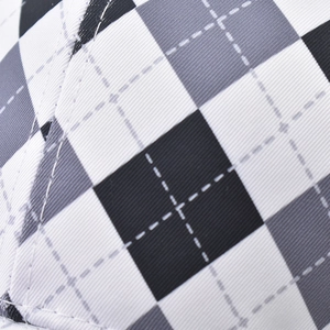 Macro view of the cotton fabric texture with a black and white diamond pattern and twill weave