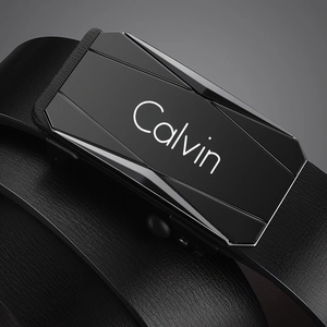 Macro shot of modern black polygon metal buckle with Calvin engraving on leather belt