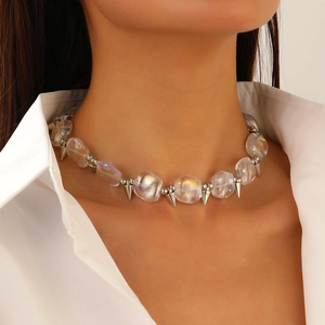 Close-up of punk Y2K necklace with iridescent beads and silver metallic spikes