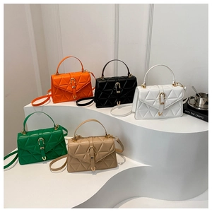 Detail of five stylish crossbody bags in various colors on geometric white steps