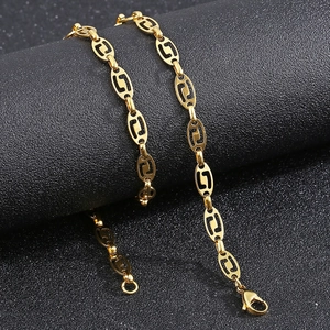 Detailed close-up of golden hollow oval link chain with secure lobster clasp closure