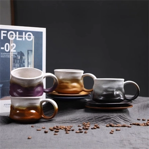 Macro view of four ceramic espresso cups and saucers with textured gradient glaze
