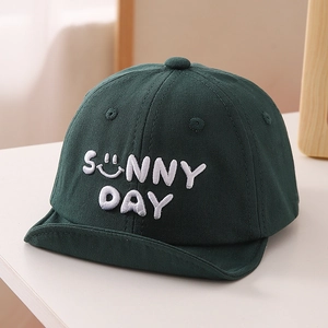Detail of baby soft brim cap featuring white Sunny Day embroidery and smiley face icon