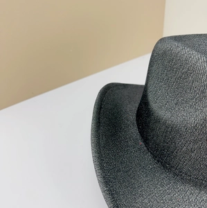 Macro view of the refined frosted texture on a classic dark grey jazz felt hat detail