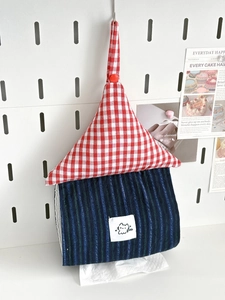 Detail of a house-shaped hanging tissue holder with red plaid and cat patterns