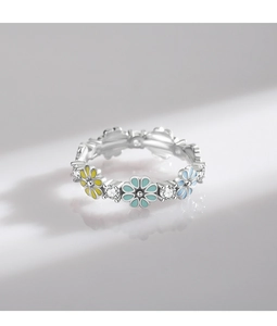 Close-up of 925 silver flower ring with colorful enamel petals and sparkling cubic zirconia