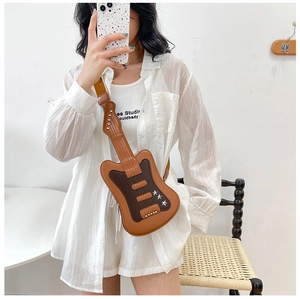 Detailed view of guitar-shaped crossbody bag with brown faux leather and star rivets