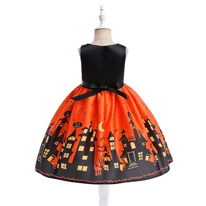 Detail view of the back of a girl's Halloween dress with black bow and pumpkin patterns