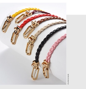 Macro detail of seven colorful braided leather belts with vintage gold metal buckles