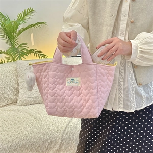 Pink quilted heart tote bag detail with Happy label and cute plush bunny charm