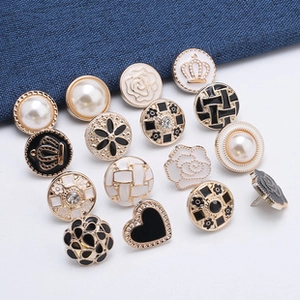 Detailed set of decorative pins and pearl buttons for waist adjustment and fashion accents