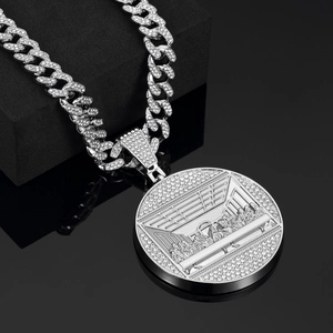 Macro shot of silver hip hop necklace with Last Supper pendant and iced out cuban chain