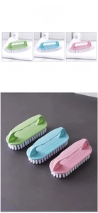 Detail of cleaning brushes in green, blue and pink with ergonomic handles and soft bristles