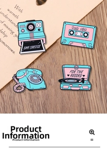 Detailed view of vintage camera, cassette, and vinyl record enamel pins on a wooden desk