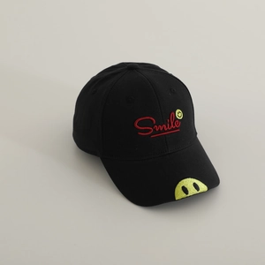 Detail of smile patch and red Smile embroidery on black cotton kids baseball cap