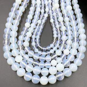 U-shaped rows of translucent white synthetic moonstone beads on a black background