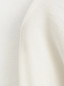 Macro detail of high-quality white cotton linen fabric showing natural woven textures