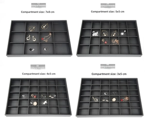 Detail view of black PU jewelry trays with 12 to 36 grids for rings and earrings