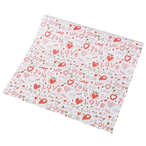Detail of hand-drawn gift wrap with red hearts and romantic English text patterns