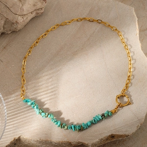 Detail of bohemian turquoise stone chips necklace with golden chain and OT toggle clasp