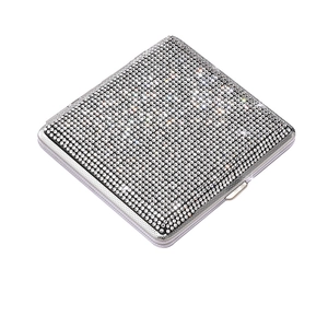 Detailed macro view of the sparkling rhinestone surface on a silver stainless steel case
