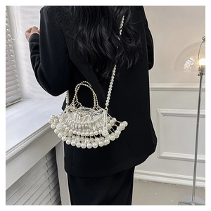 Crossbody pearl evening bag with unique bead-woven structure on female model