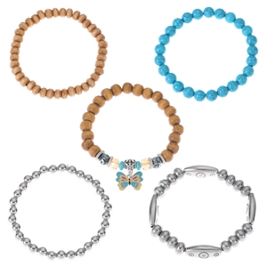 Detail of five-piece elastic beaded bracelet set with wood beads and butterfly charm