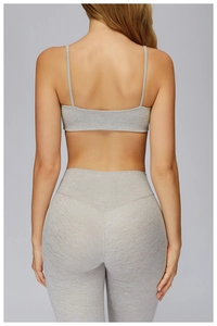Close-up back view of grey marl yoga set featuring racerback bra and high-waisted leggings