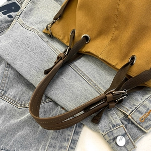 Japanese retro canvas bucket bag with leather handles in a stylish 45-degree angle view