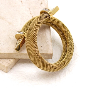 Detail of gold mesh woven nail bracelet with sparkling cubic zirconia pavé stones