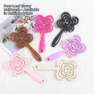 Detail view showing six colorful clover-shaped vented hairbrushes for scalp massage