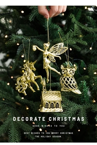 Detailed view of golden Christmas tree ornaments featuring unicorn and fairy designs
