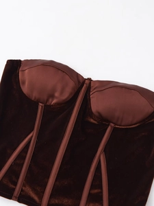 Detailed close-up of brown velvet and satin corset top with fishbone support structure
