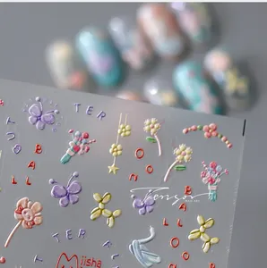 Detail of 3D embossed nail stickers featuring colorful butterflies and balloon dog designs