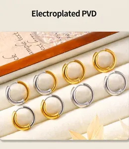 Detailed view of PVD electroplated gold and silver hoop earrings on velvet display