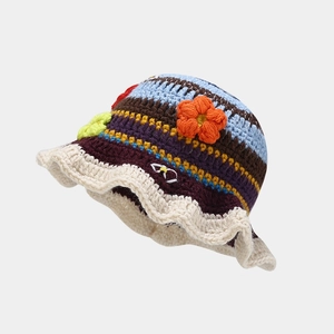 Detailed view of handmade crochet bucket hat with colorful stripes and floral accents