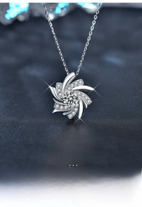 Macro shot of S925 silver windmill pendant necklace with sparkling moissanite stones