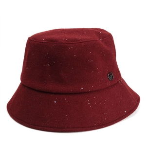 Detail of burgundy wool bucket hat featuring shimmering silver sequins and round metal logo
