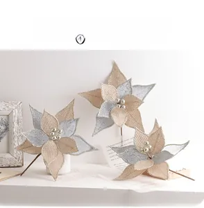 Detailed view of champagne gold artificial Christmas flowers with glitter and pearl centers