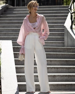 Detail view of a pink long sleeve chiffon blouse with lace top and high waist pants
