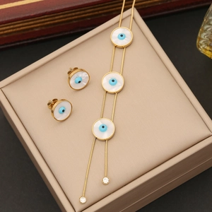 Gold stainless steel jewelry set with blue eye pattern on white shell base pendant