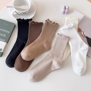 Detailed fan-shaped layout of ruffled cotton socks in multiple neutral warm colors