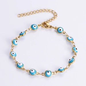 Close-up of golden chain bracelet featuring twelve blue enamel Evil Eye charms