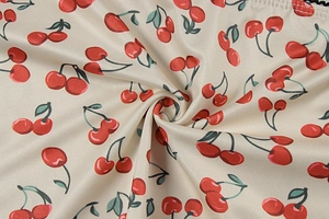 Detailed macro view of soft floral cherry print fabric with smooth satin texture