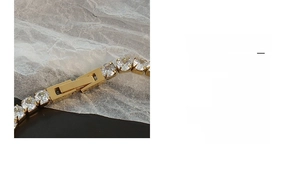 Close-up of 18K gold-plated tennis bracelet featuring a secure fold-over clasp and zircons