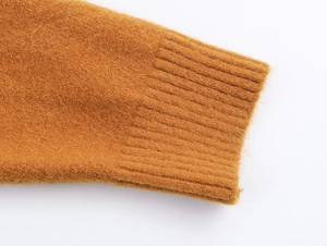 Détail des poignets côtelés d'un cardigan en maille marron à texture douce et velue