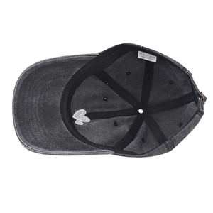 Detail view of washed cotton baseball cap interior with 100% cotton label and metal buckle